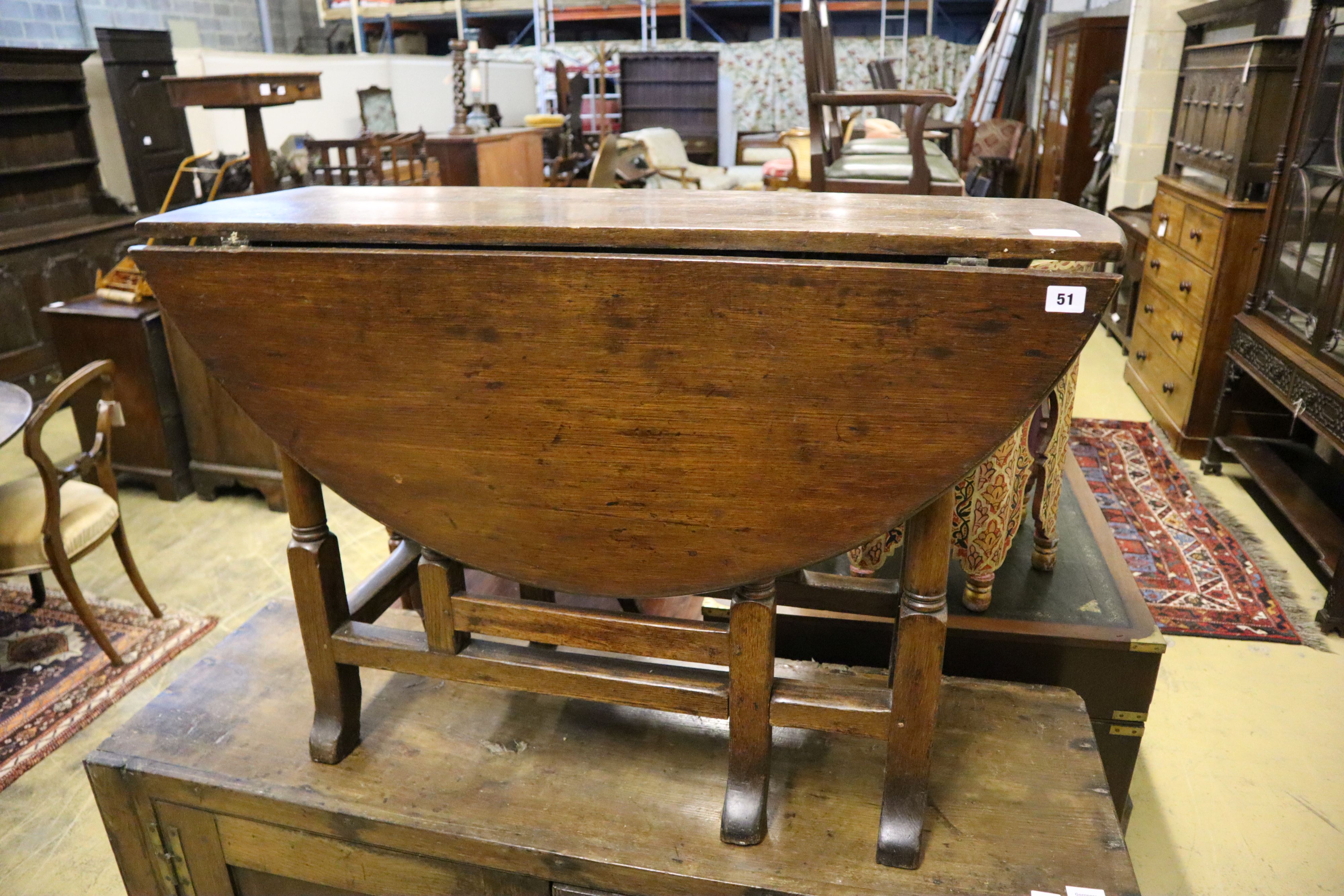 An early 18th century oak gateleg table, width 105cm, depth 38cm, height 70cm